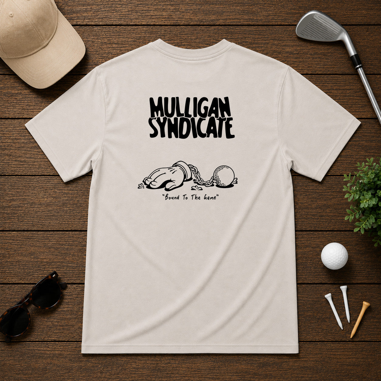 Mulligan Syndicacte Bound To The Game-  Cartoon hand connected to a golf ball by a chain. Sarcastic funny joke humor golf tee.