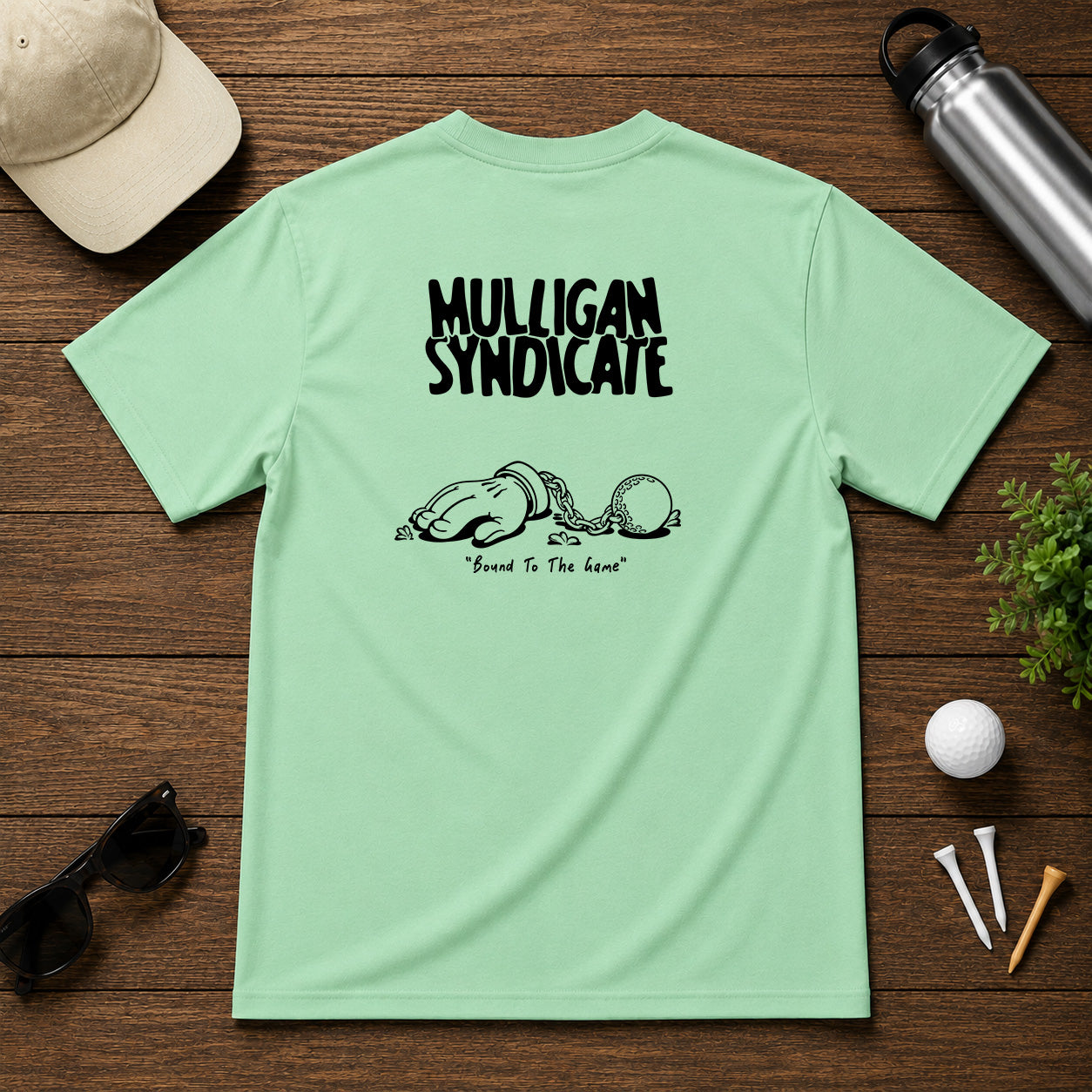 Mulligan Syndicacte Bound To The Game-  Cartoon hand connected to a golf ball by a chain. Sarcastic funny joke humor golf tee.
