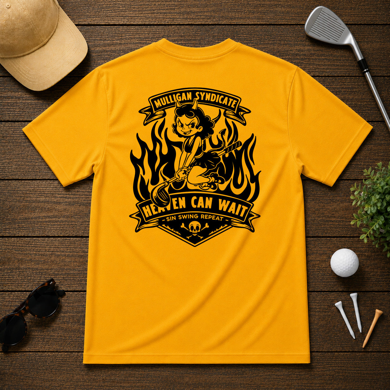 Retro style golf pinup tee shirt. Devilish girl ridding on a golf club, with flames in the background, with the saying Heaven Can Wait.