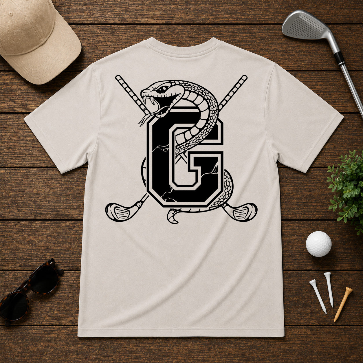 Varsity style golf shirt with a snake wrapped around the letter "G", with a pair of golf clubs in the back.