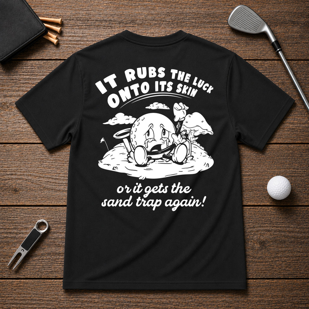 It Rubs The Luck Onto Its Skin- Funny sarcastic joke shirt for golfers that have bad luck on the golf course. Funny golf ball character rubbing luck lotion in itself, in hopes of getting to the hole.