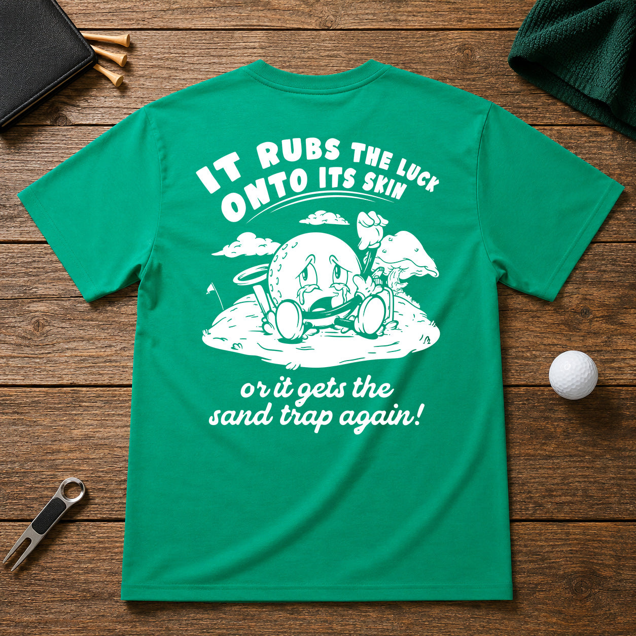 It Rubs The Luck Onto Its Skin- Funny sarcastic joke shirt for golfers that have bad luck on the golf course. Funny golf ball character rubbing luck lotion in itself, in hopes of getting to the hole.